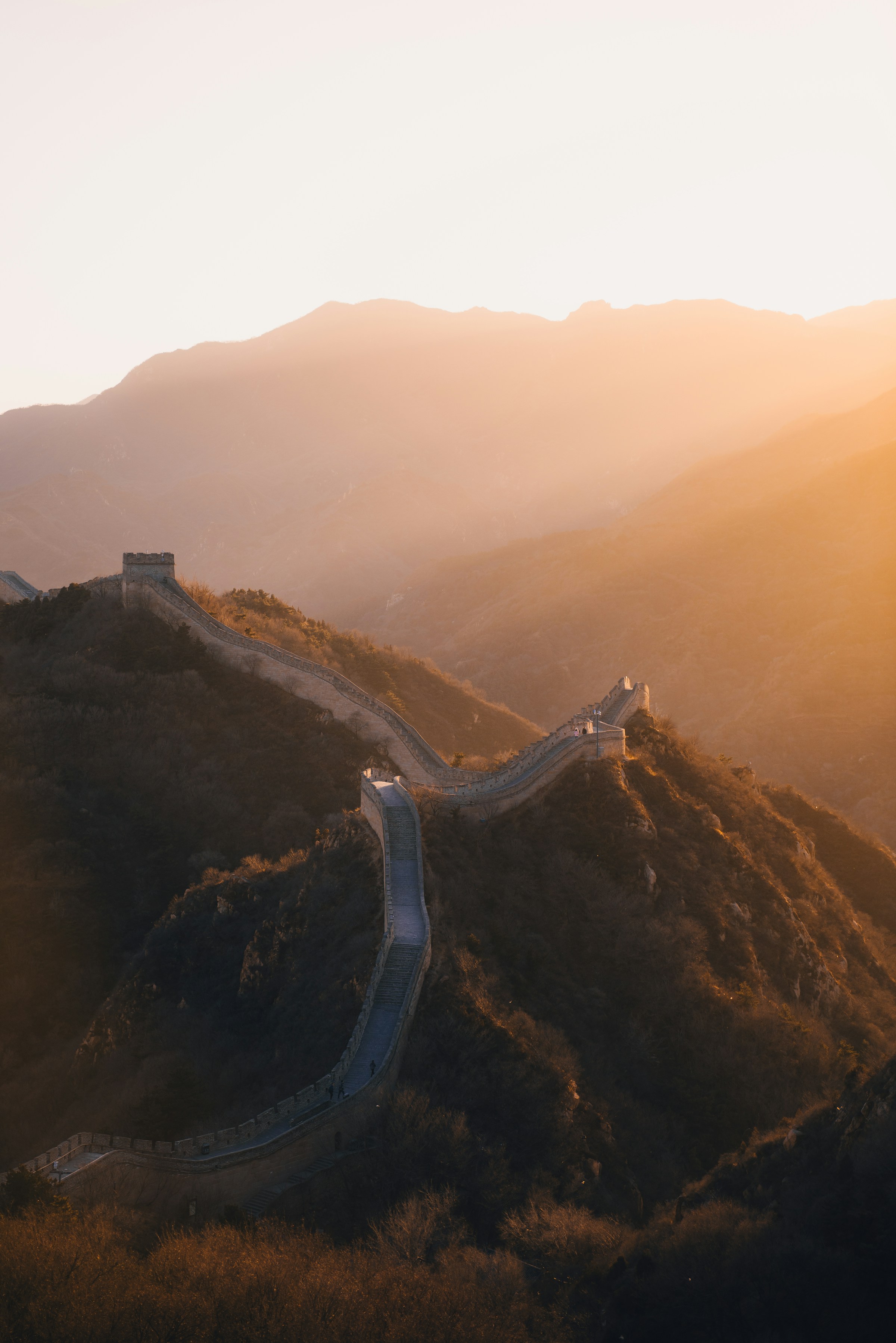 The Great Wall winding over mountain ridges at sunrise