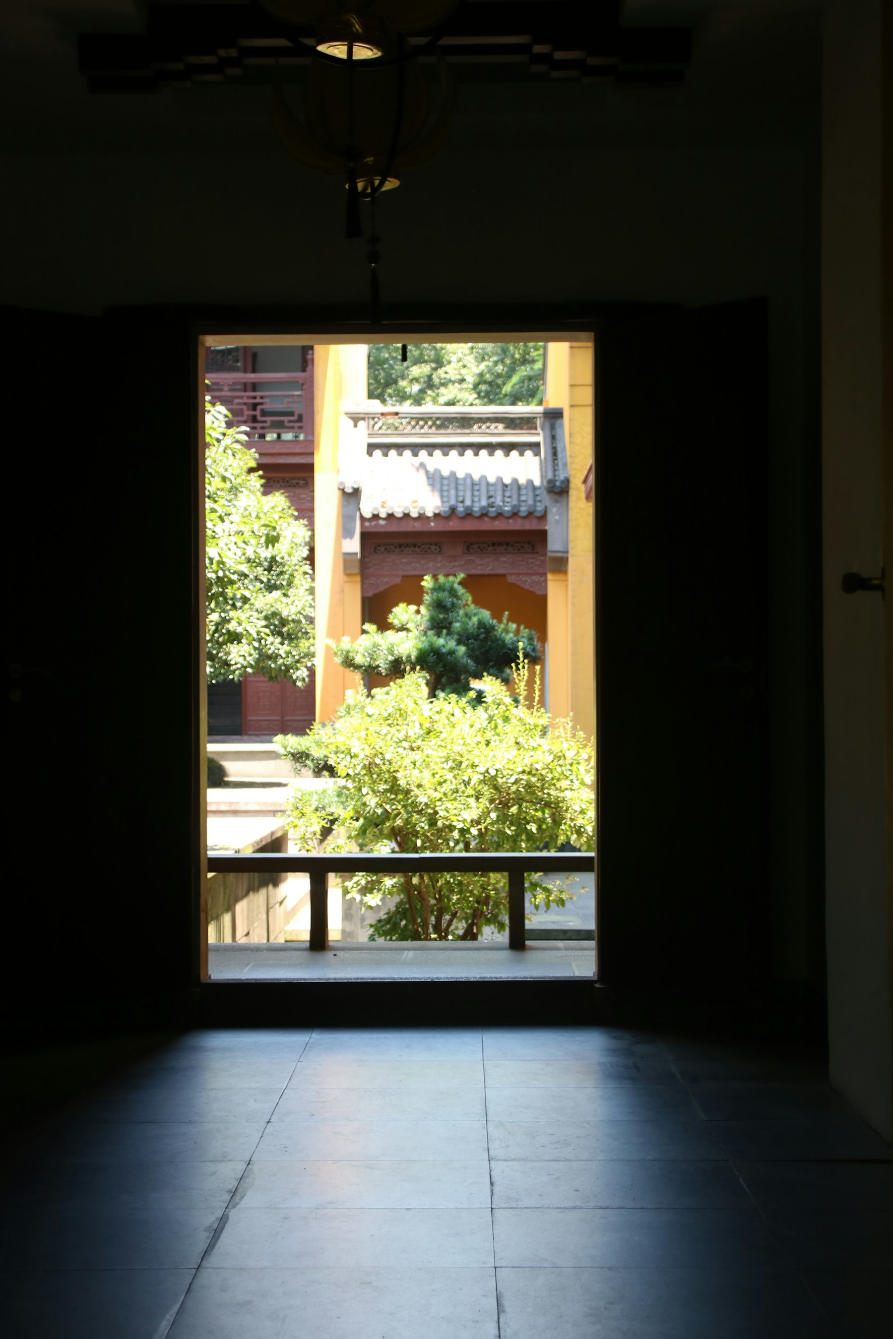 An open doorway leading into a quiet Chinese courtyard
